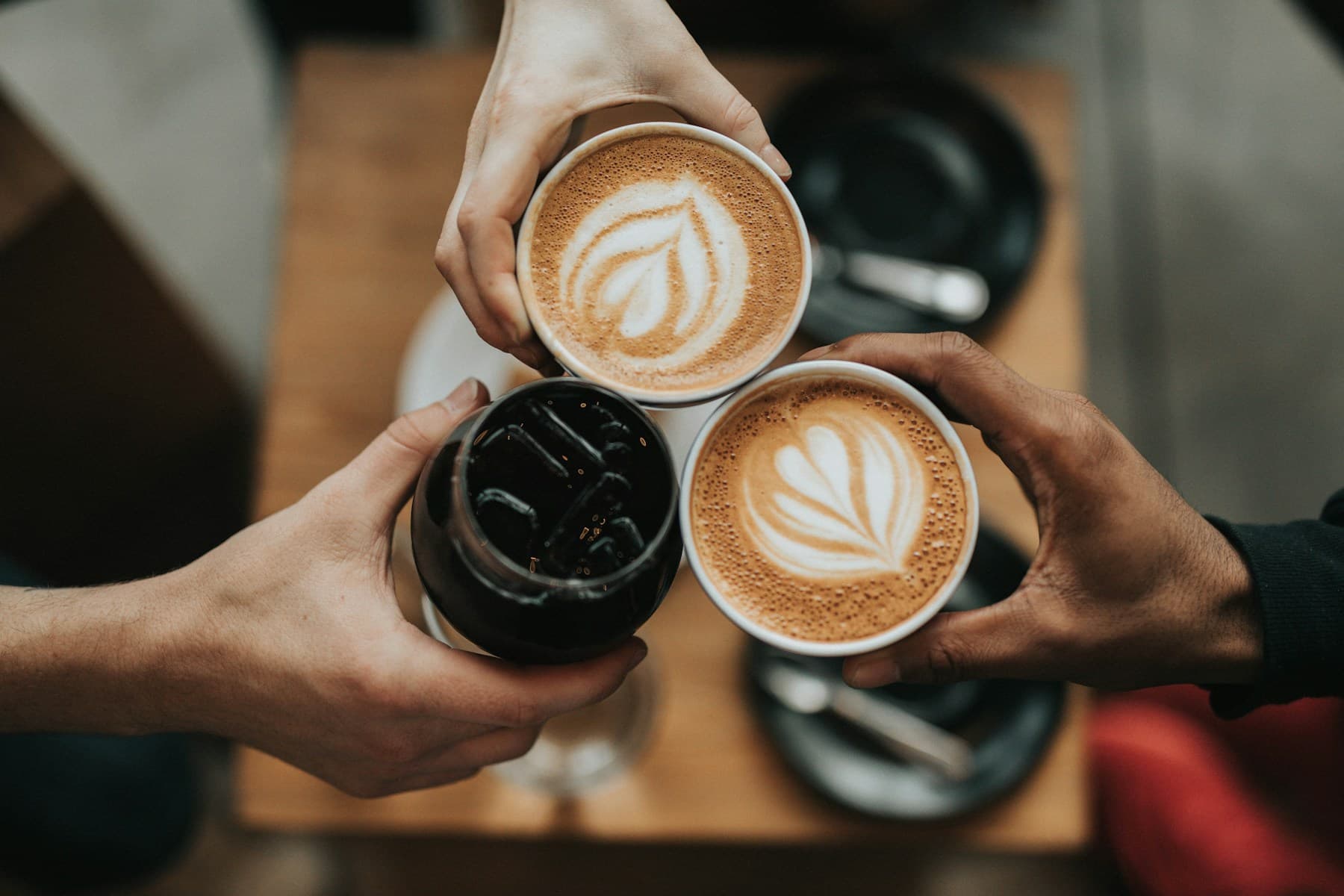 Three people sharing coffee together